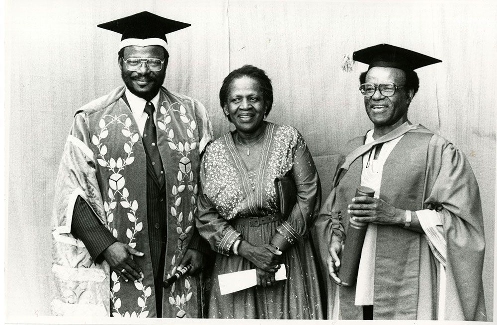 Mphahlele receives an Honorary Doctorate from the University of Natal, 1983. Rebecca stands between Es’kia and Mangosuthu Buthelezi.