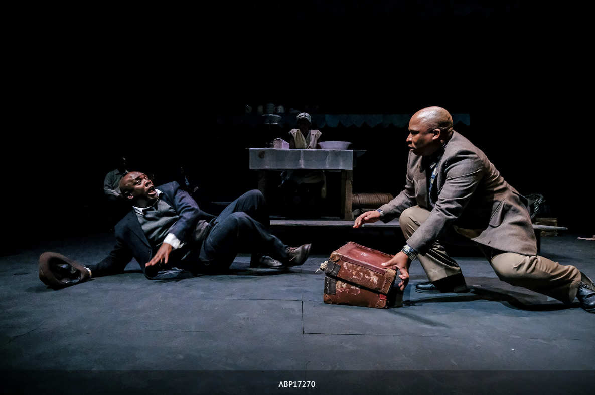 ‘The Suitcase‘ is one of Mphahlele‘s most popular short stories. This is a cautionary tale about a man who claims a suitcase that was abandoned on a bus. He is confronted by the police, who open the suitcase and make a shocking discovery. ‘The Suitcase‘ first appeared in Drum magazine in 1955. It was adapted into a play by James Ngcobo, and has been performed in South Africa and internationally. Siyabonga Thwala, Masasa Mbangeni, Desmond Dube and John Lata featured in the above performance in Liverpool (U.K.) in 2017. Andrew Billington.